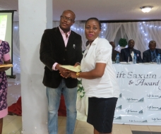 Commissioner for Youth and Sports presenting a certificate to Favour Nnaemeka