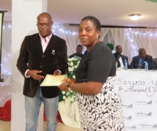 Commissioner for Youth and Sports presenting a certificate to Stella Nwoye