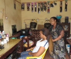 A beneficiary of Enterprising Women in her beauty saloon